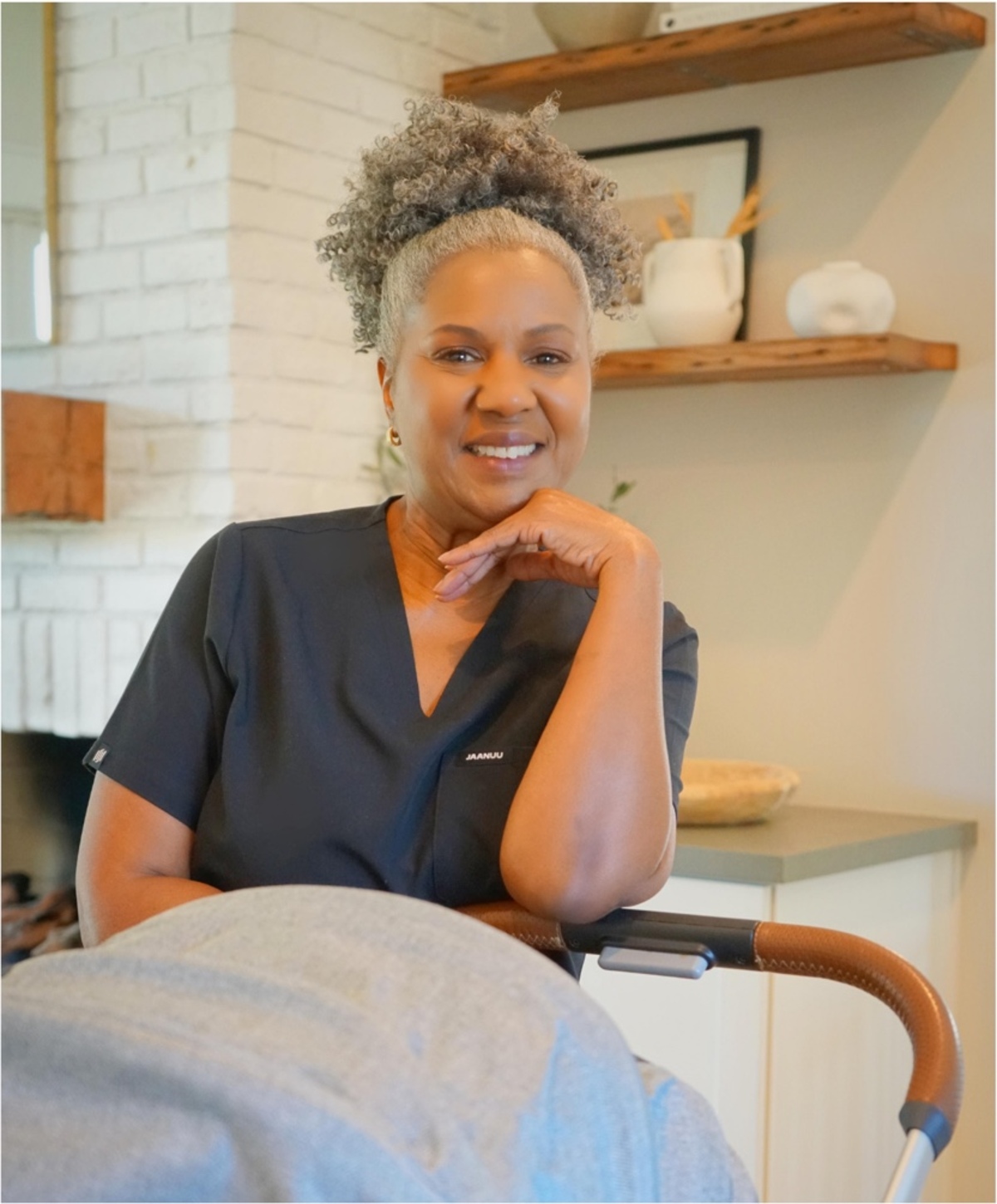 Stephaney smiling in her newborn care uniform